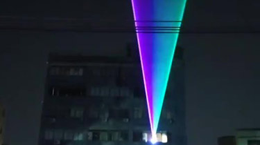 Building using outdoor landmark laser effect display